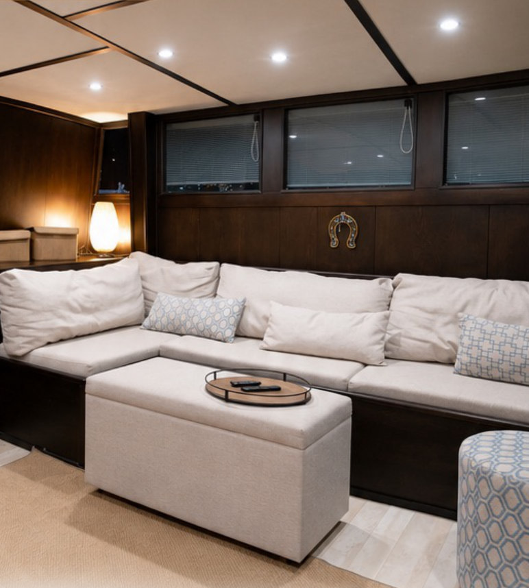 Salon with cream sofas and dark wood panelling